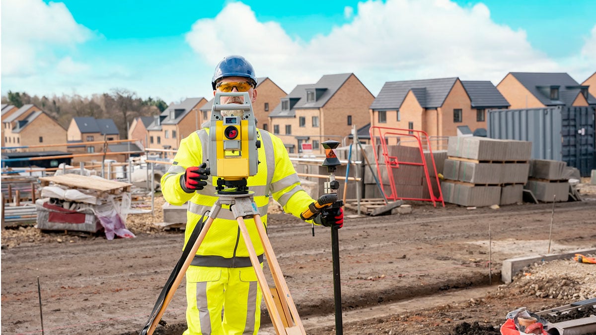 Heat Burden Male construction worker wearing PPE doing surveying on a construction site