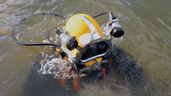 Commercial Diver Commercial diver prepares to descend below fishing vessel to perform repairs. Image credit: / Images Plus