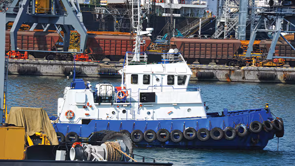 Tugboat and port cargo cranes. Credit:  /  Images Plus