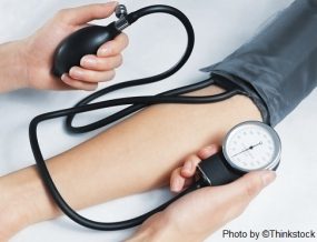 M3F Two arms are visible with blood pressure being taken with a sphygmomanometer