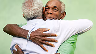 Two men hugging