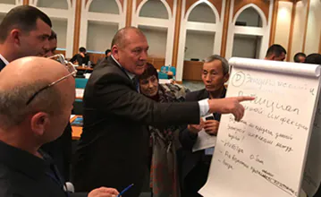 Experts from participating ministries work together to identify criteria used to define the national importance of zoonotic diseases during the OHZDP Workshop. Photo credit: Tory Seffren