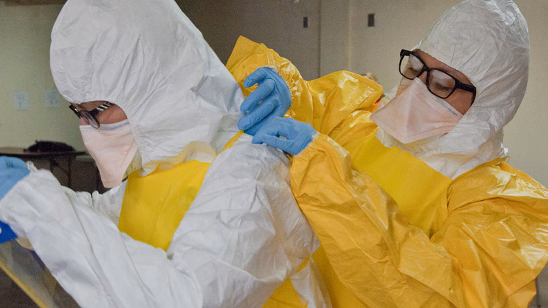 Employees putting on personal protective equipment.