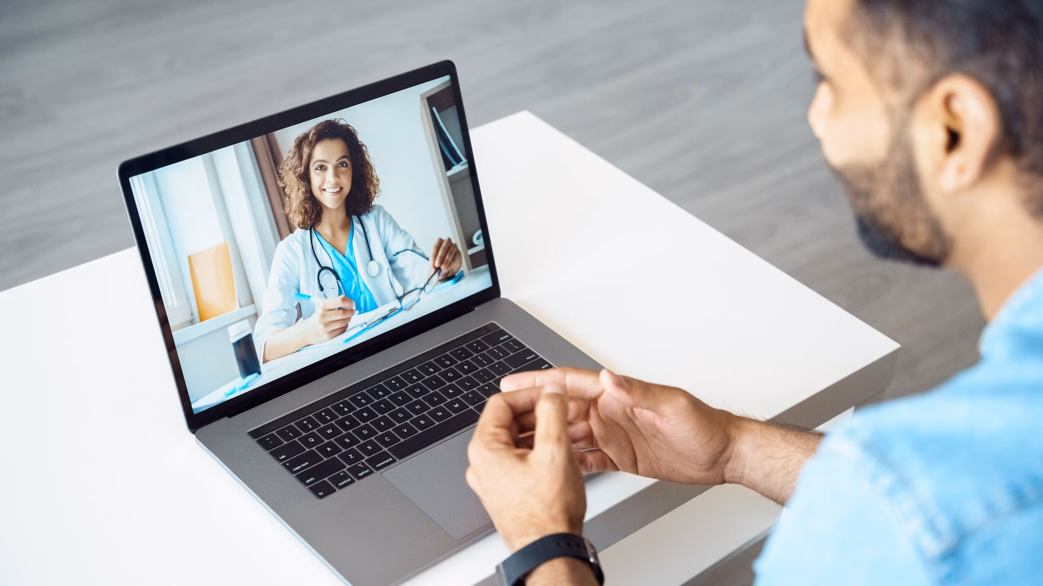 A man on a telehealth appointment with his doctor.