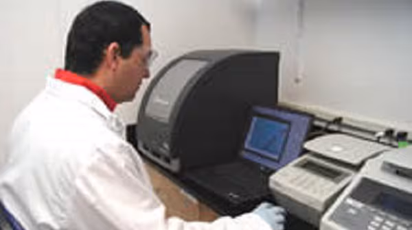 CDC scientist reviews real-time PCR results