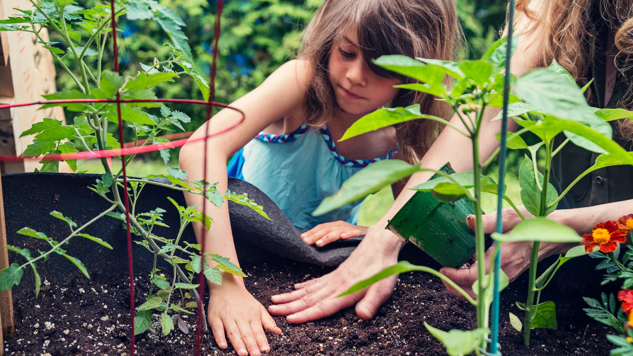 Mother and daughter planting mother and daughter planting