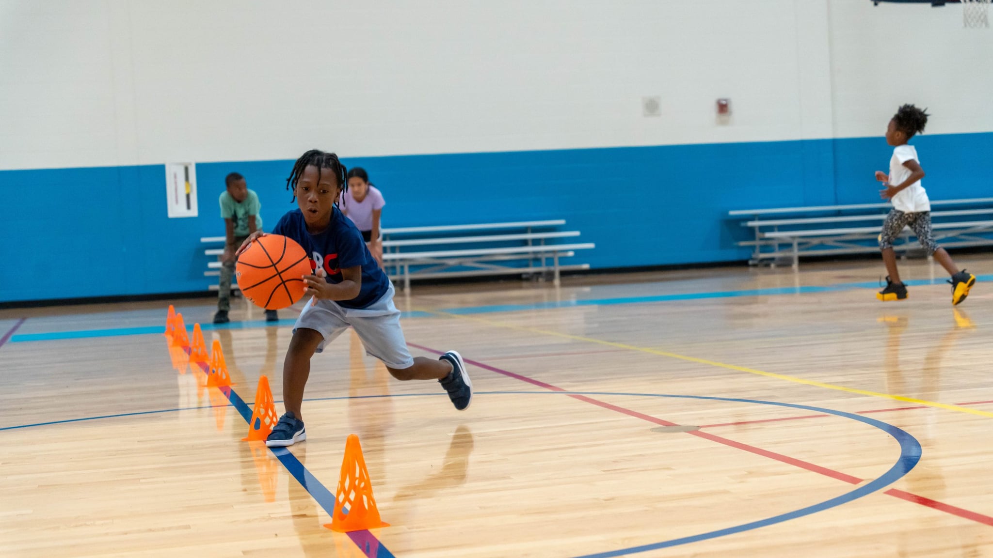 — title missing — Kids playing basketball in a school gym.