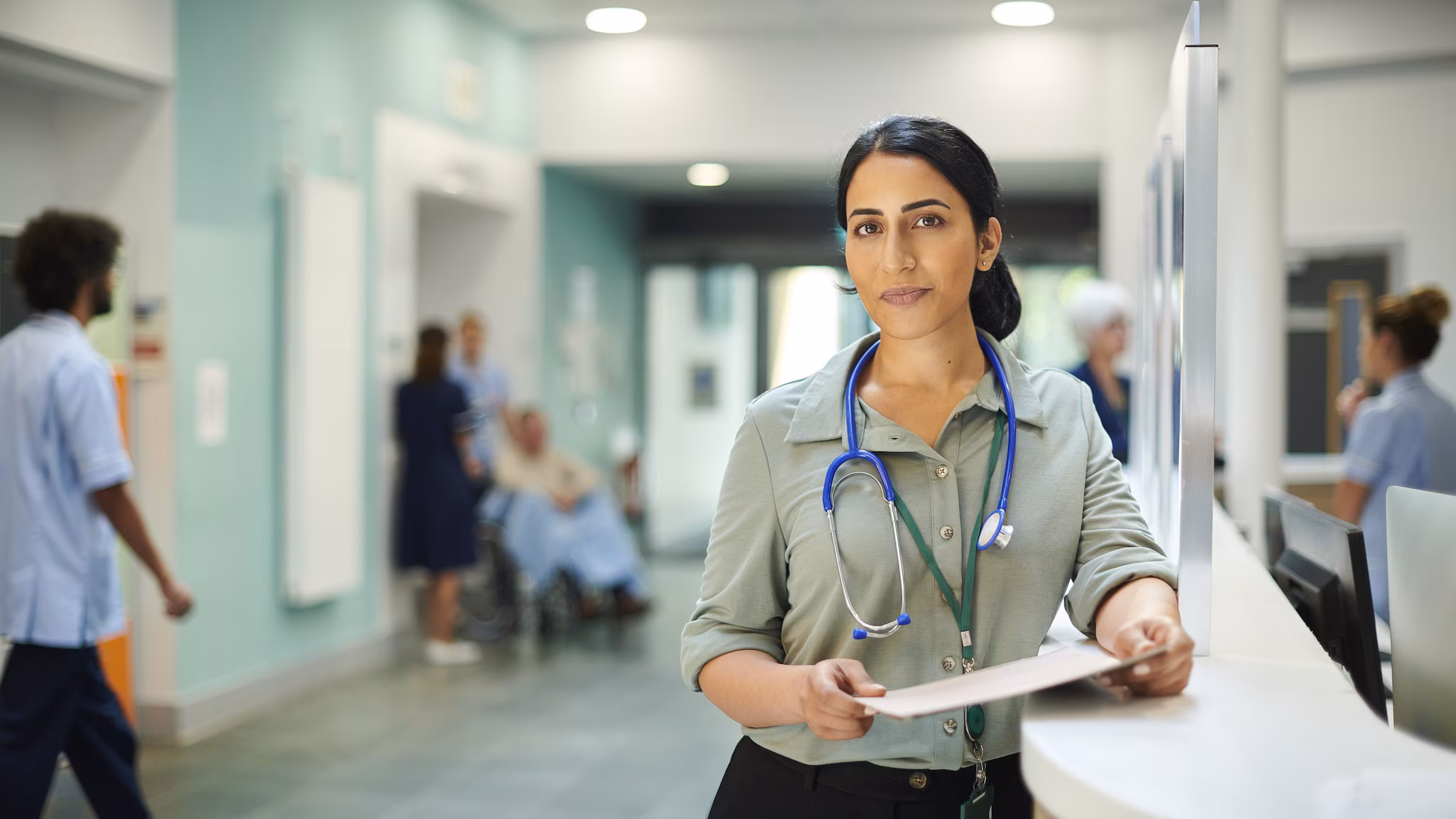 medical care for rabies Female doctor stands in medical facility wearing a green shirt and stethoscope