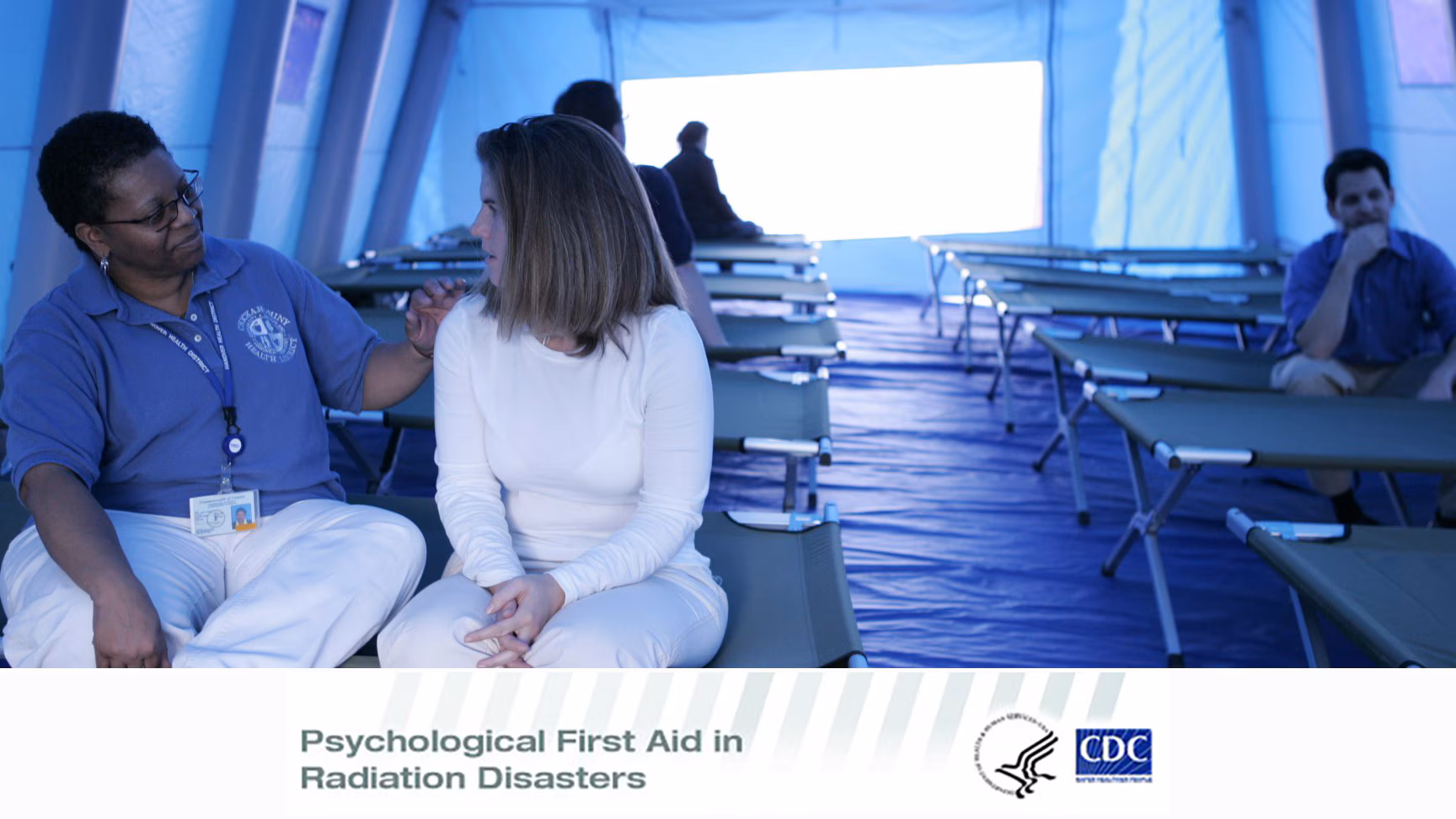 Psychological First Aid Field staff talking to a woman while sitting on a cot. Text says "Psychological First Aid in Radiation Disasters"