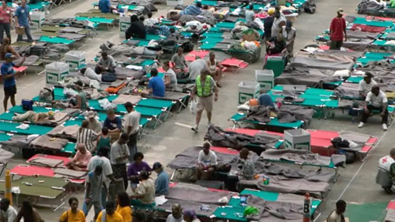 Emergecny Shelter People gathererd on cots in an emergency shelter.