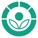 Radura symbol for food irradiation. Symbol is a green label showing two hollow leaves with a filled in circle above it making the shape of a flower. The whole flower is surrounded by a circle that is broken up into bands on the top.
