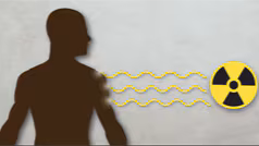 A silhouette of a man being hit with waves of toxic radiation.