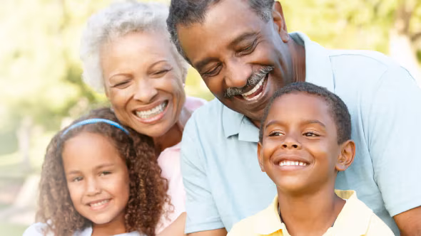Grandparents enjoying a day outside with their granddaughter and grandson.