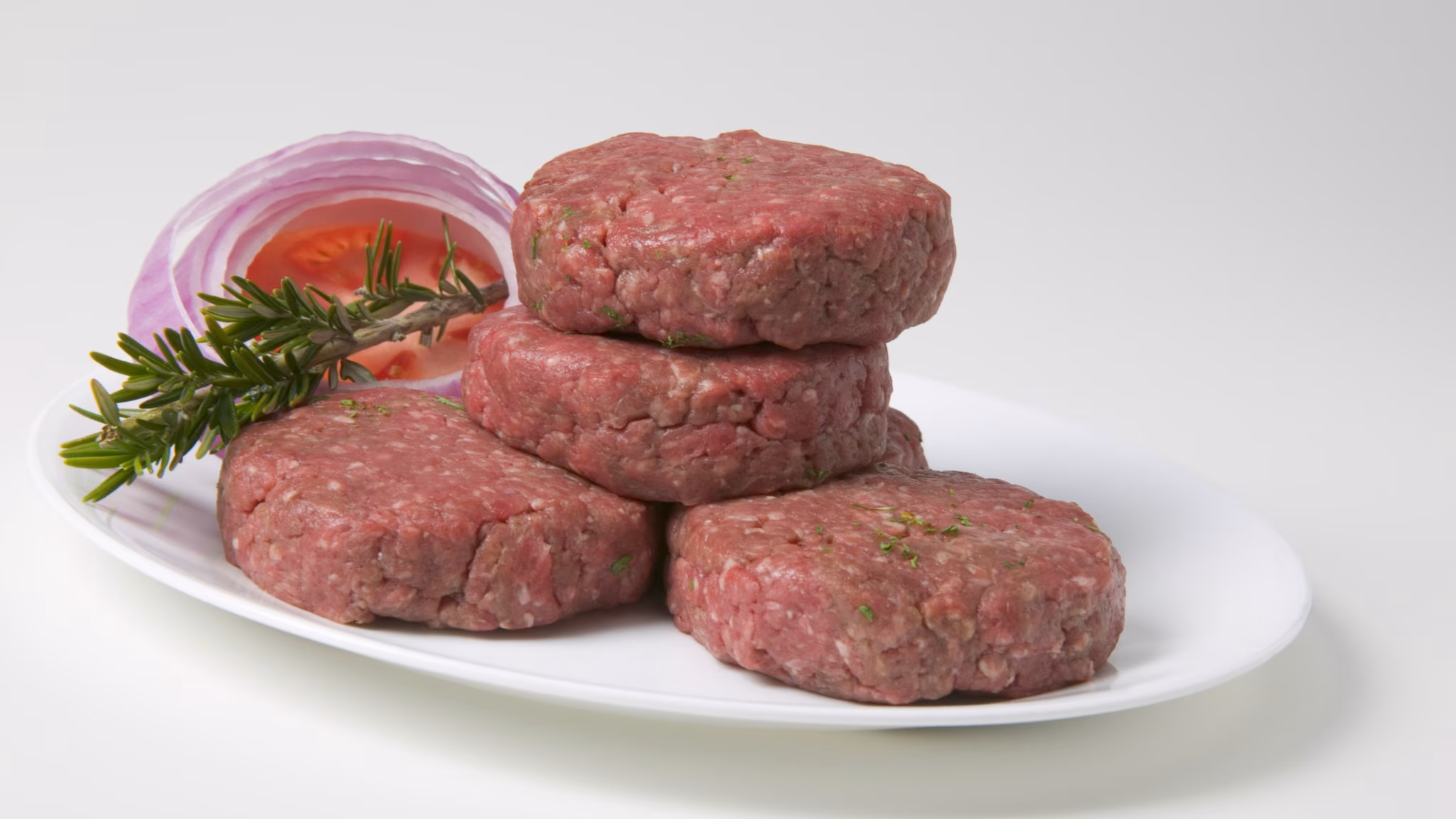 plate with patties of ground beef