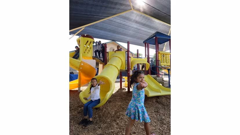 Children playing under a shade structure funded by the American Academy of Dermatology