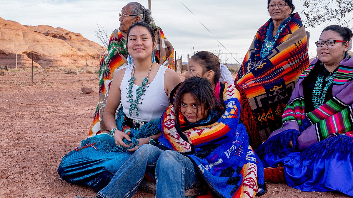 Female Navajo Family Multiple generations of female Navajos together, wrapped in customary blankets in Monument Valley.