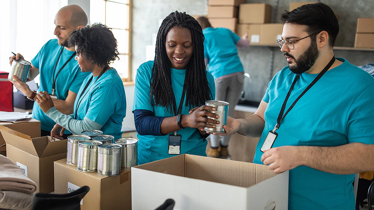 Food Bank Team of volunteers working together for their community at food bank.