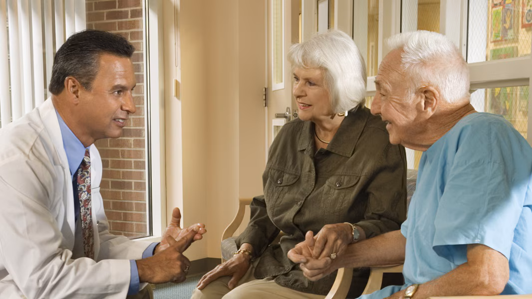 Doctor speaking to an older couple