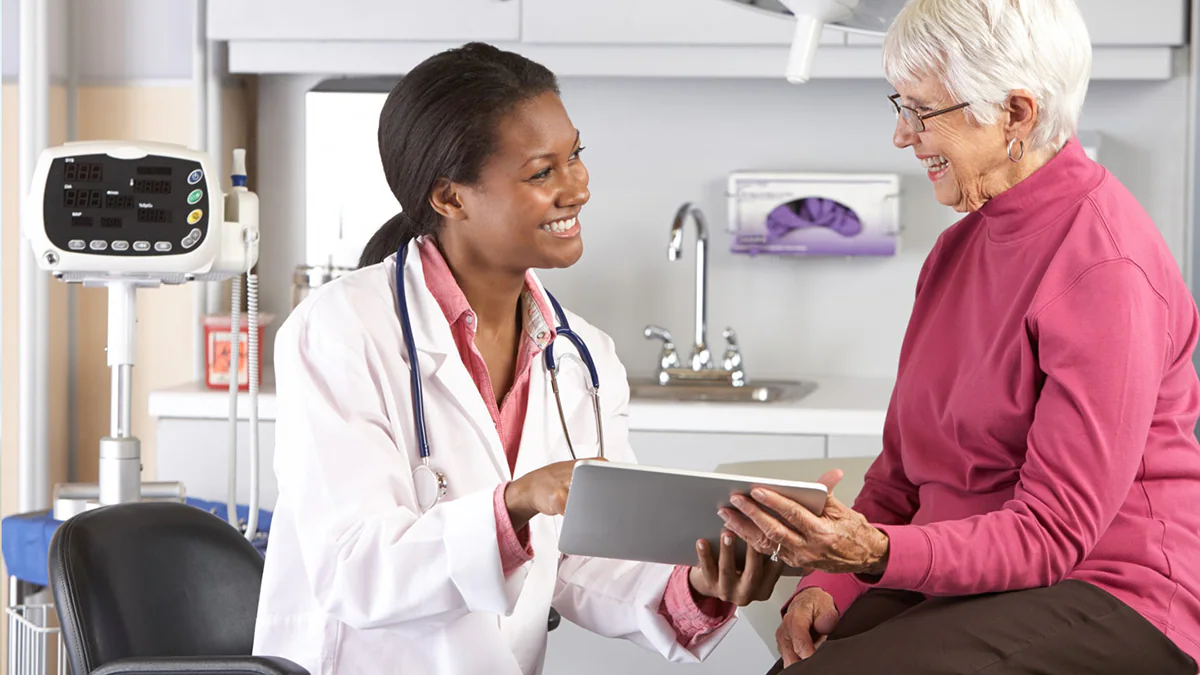 doctor-patient Doctor talking with elderly patient and showing her something on a tablet