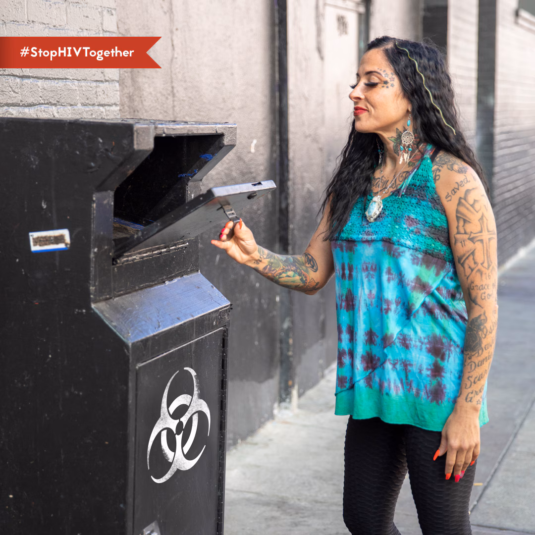 Harm reduction to prevent HIV Person opening sharps/needles drop off box.