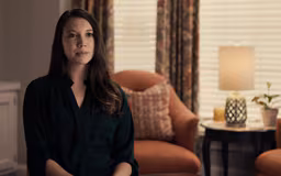 video5 White female sitting in room with window and chair behind her talking to camera