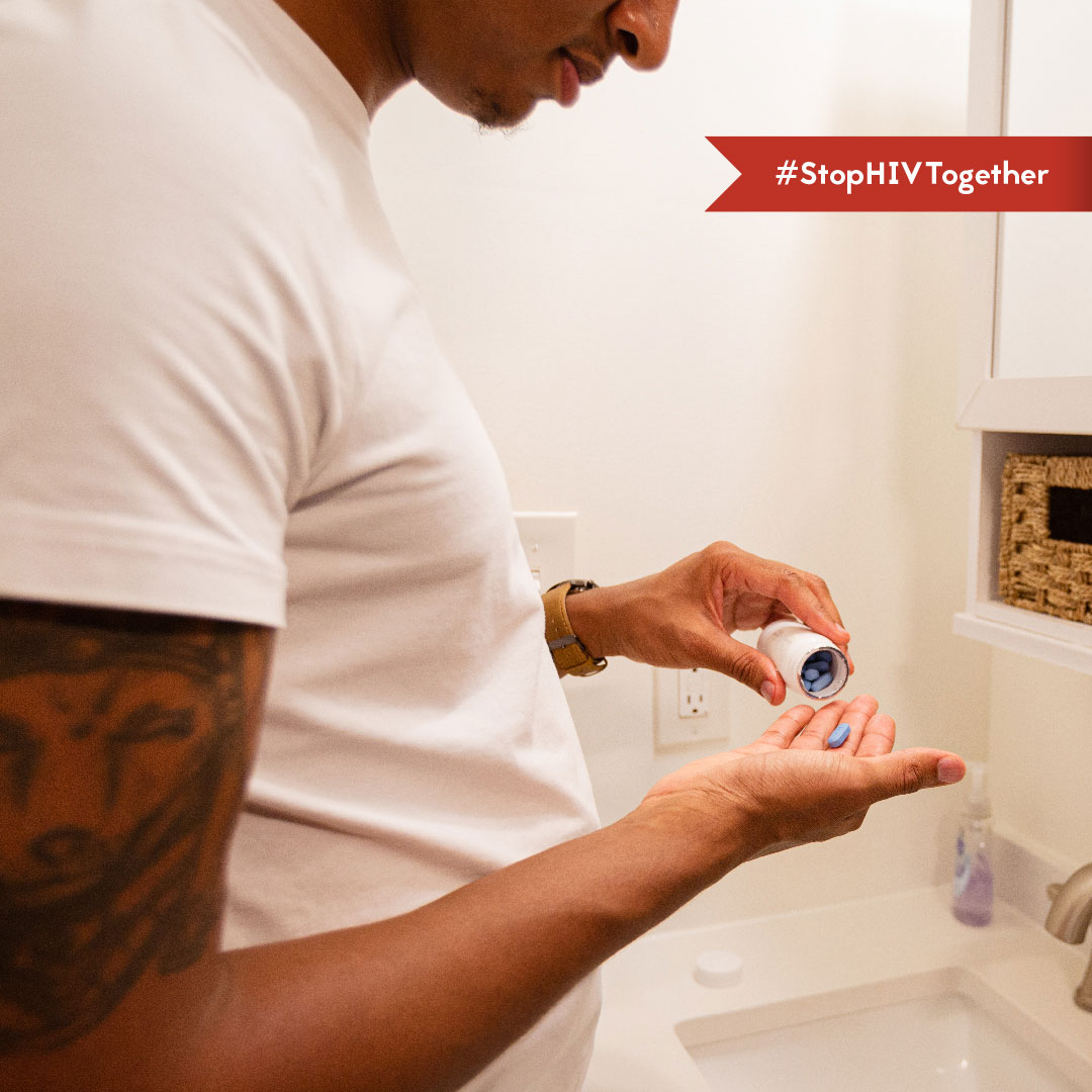 PrEP – Brandon An image of a man taking a PrEP pill in his bathroom.