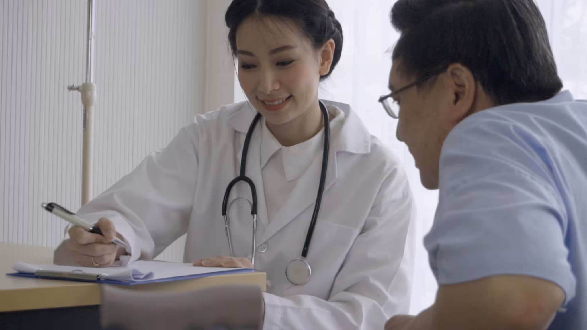 Healthcare Provider and Patient A health care provider reviews an informational chart.