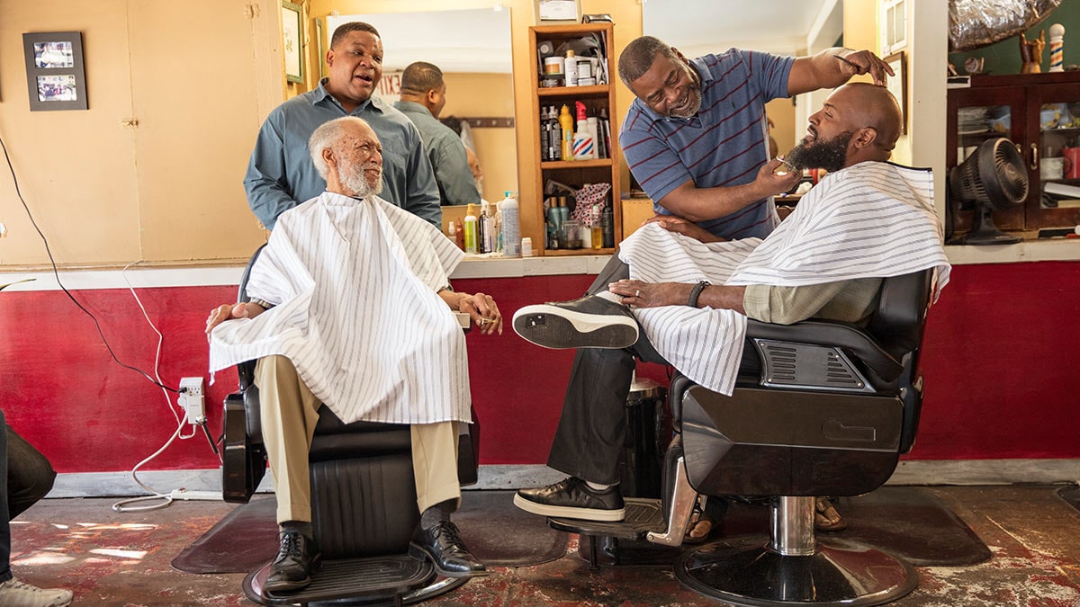 Black AA Barbershop A group of African American men in a barbershop.