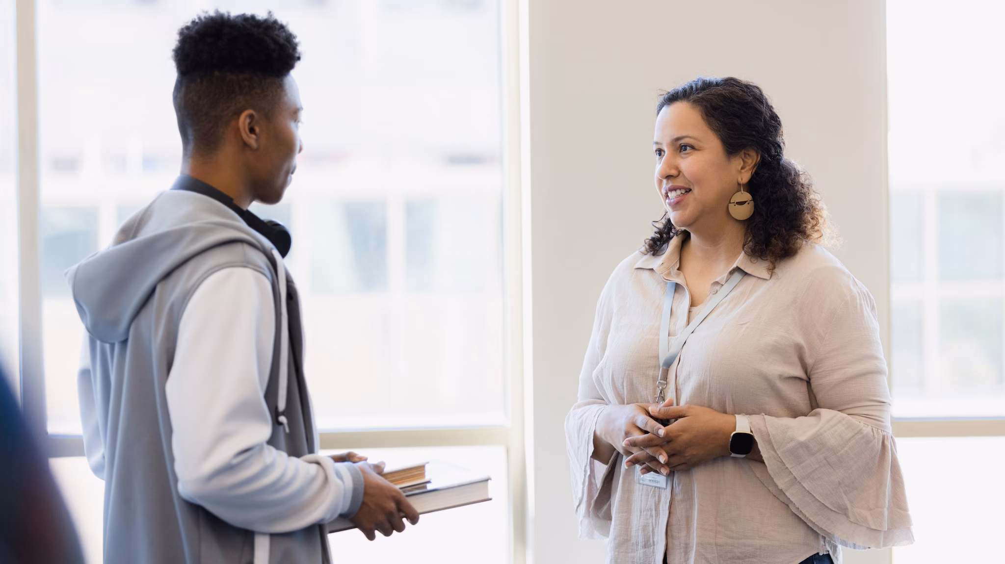 Teacher talks with student in the halls. Teacher talks with student in the hall about e-cigarettes.