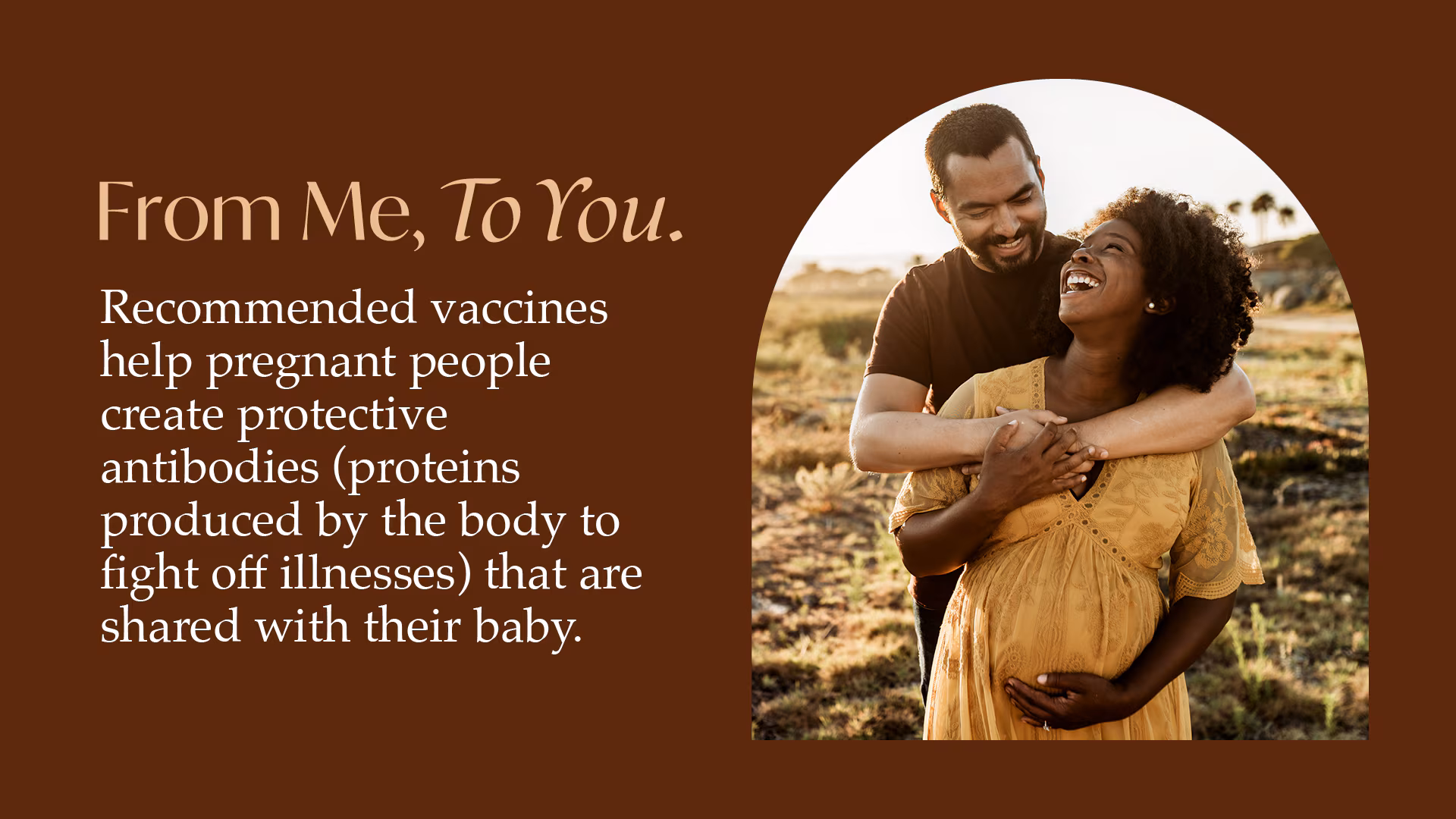 An adult couple hugging in a field.