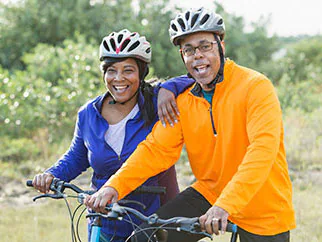 Glaucoma awareness healthy habits African American couple on bikes