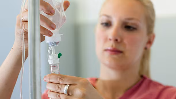 Nurse setting up an IV drip