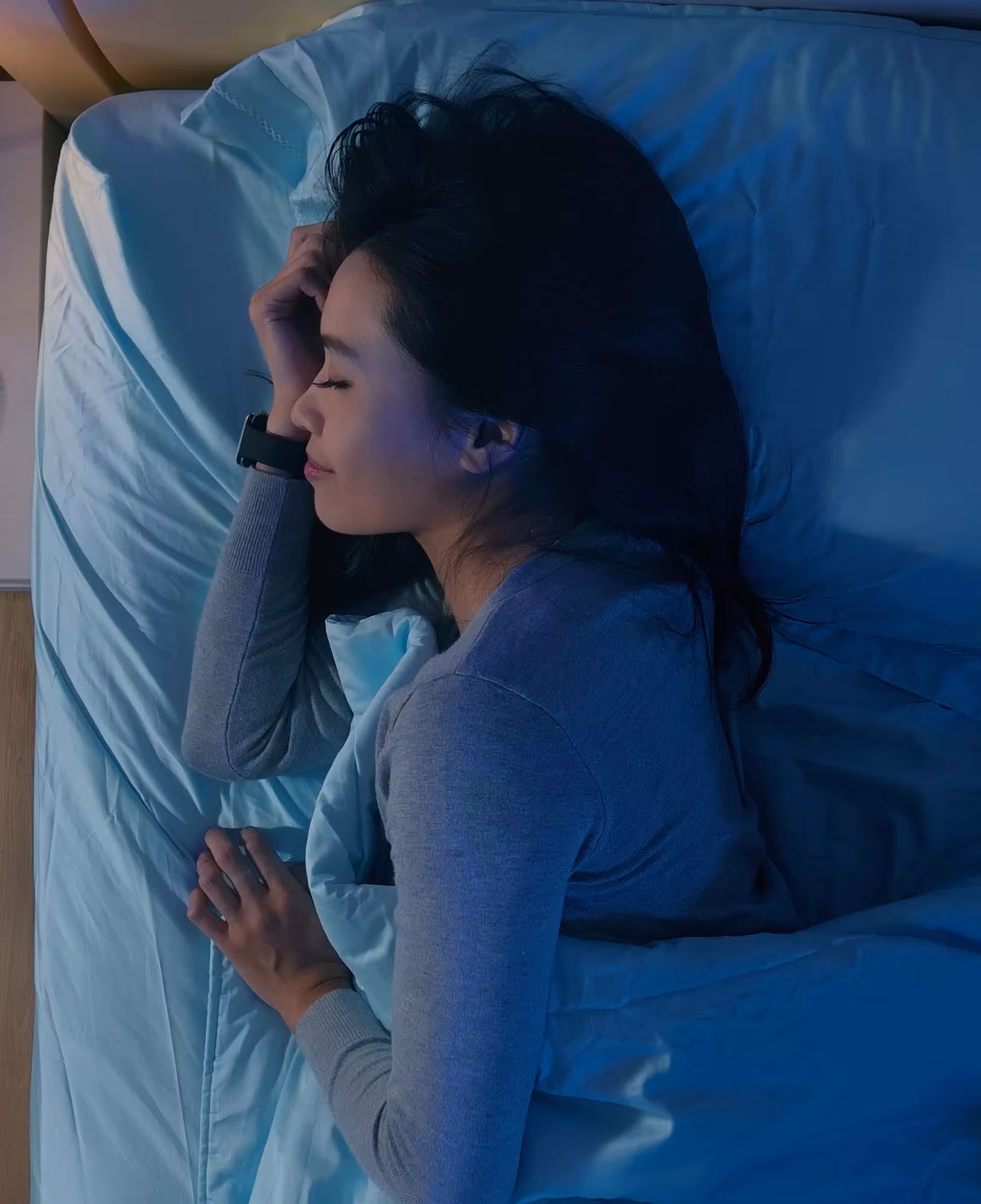 A woman gets a good night's rest in a dimly lit room. Photo credit: /RyanKing999